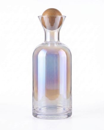 Iridescent glass bottle with a round wooden stopper against a white background, decorative piece.