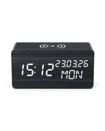 Wooden digital alarm clock showing 15:12, date 23.03.26, MON, with wireless symbol on top.