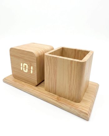 Wooden desk organizer with a small digital clock and a square pen holder on a matching base