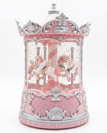 Pink ornate carousel music box with silver detailing and two unicorn figures inside a glass case, surrounded by confetti-like glitter.