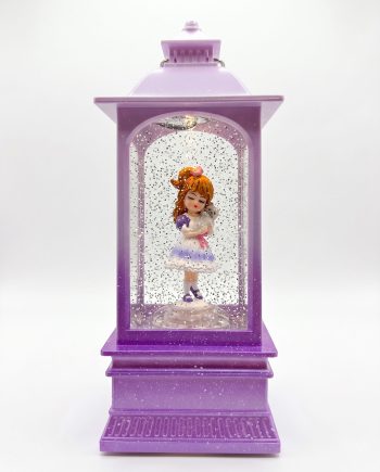 Purple decorative lantern with a glass display showing a girl figurine in a purple-and-white dress holding a small grey animal, surrounded by glitter snow.