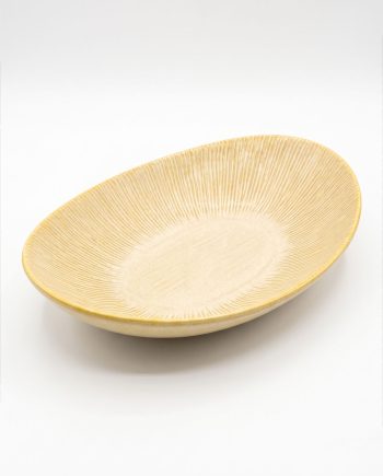 Beige oval ceramic bowl with a ridged, sunburst interior on a white background, empty and clean.