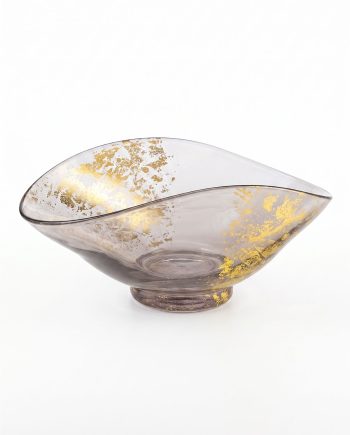 Decorative glass bowl with gold leaf flecks and a shallow, curved form on a small pedestal base.